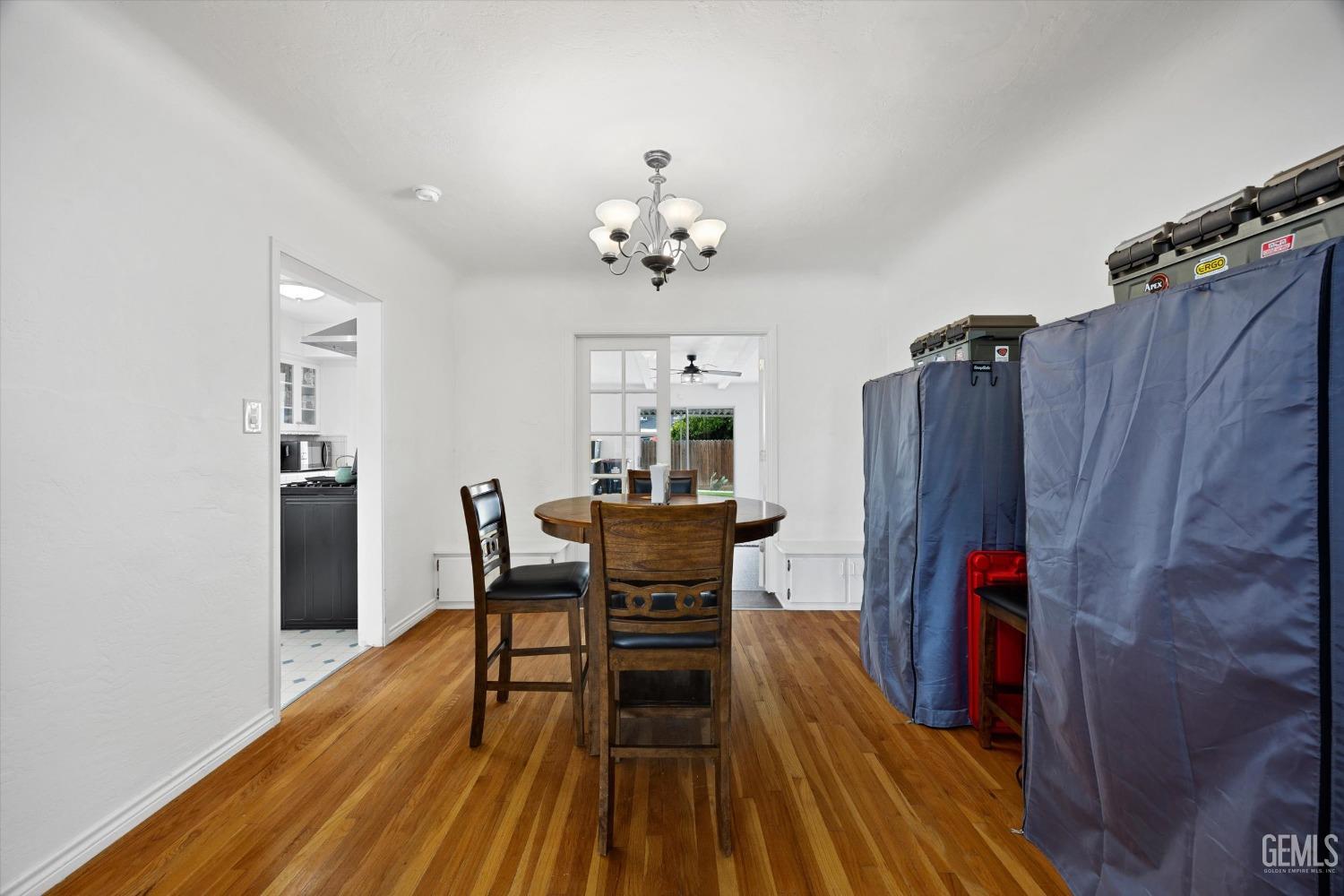 Undisclosed Address Bakersfield, CA 93305 - Photo 17 of 46 a dining room with furniture and wooden floor