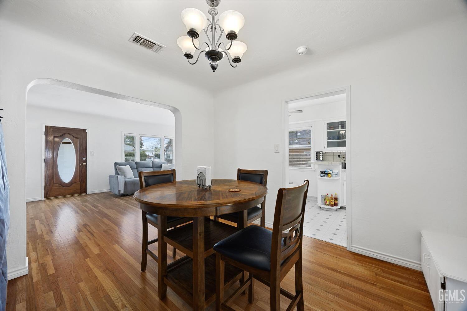 Undisclosed Address Bakersfield, CA 93305 - Photo 18 of 46 a view of a dining room with furniture and wooden floor