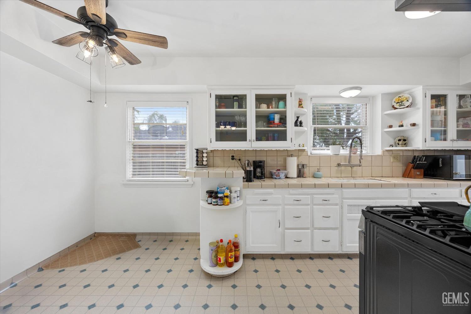 Undisclosed Address Bakersfield, CA 93305 - Photo 22 of 46 a kitchen with stainless steel appliances a stove a sink and a refrigerator
