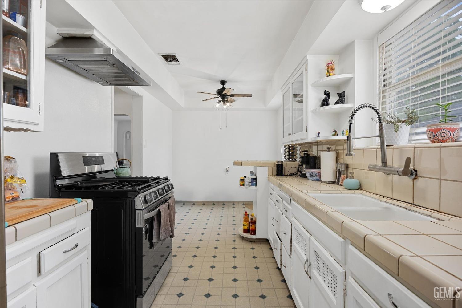 Undisclosed Address Bakersfield, CA 93305 - Photo 26 of 46 a kitchen with stainless steel appliances a stove a sink dishwasher and cabinets
