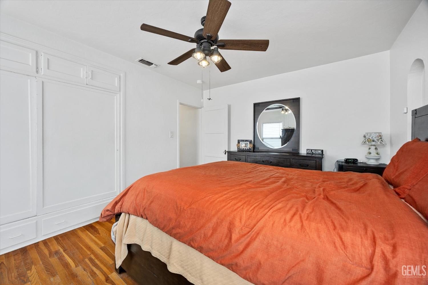 Undisclosed Address Bakersfield, CA 93305 - Photo 28 of 46 a bed sitting in a bedroom and a chandelier