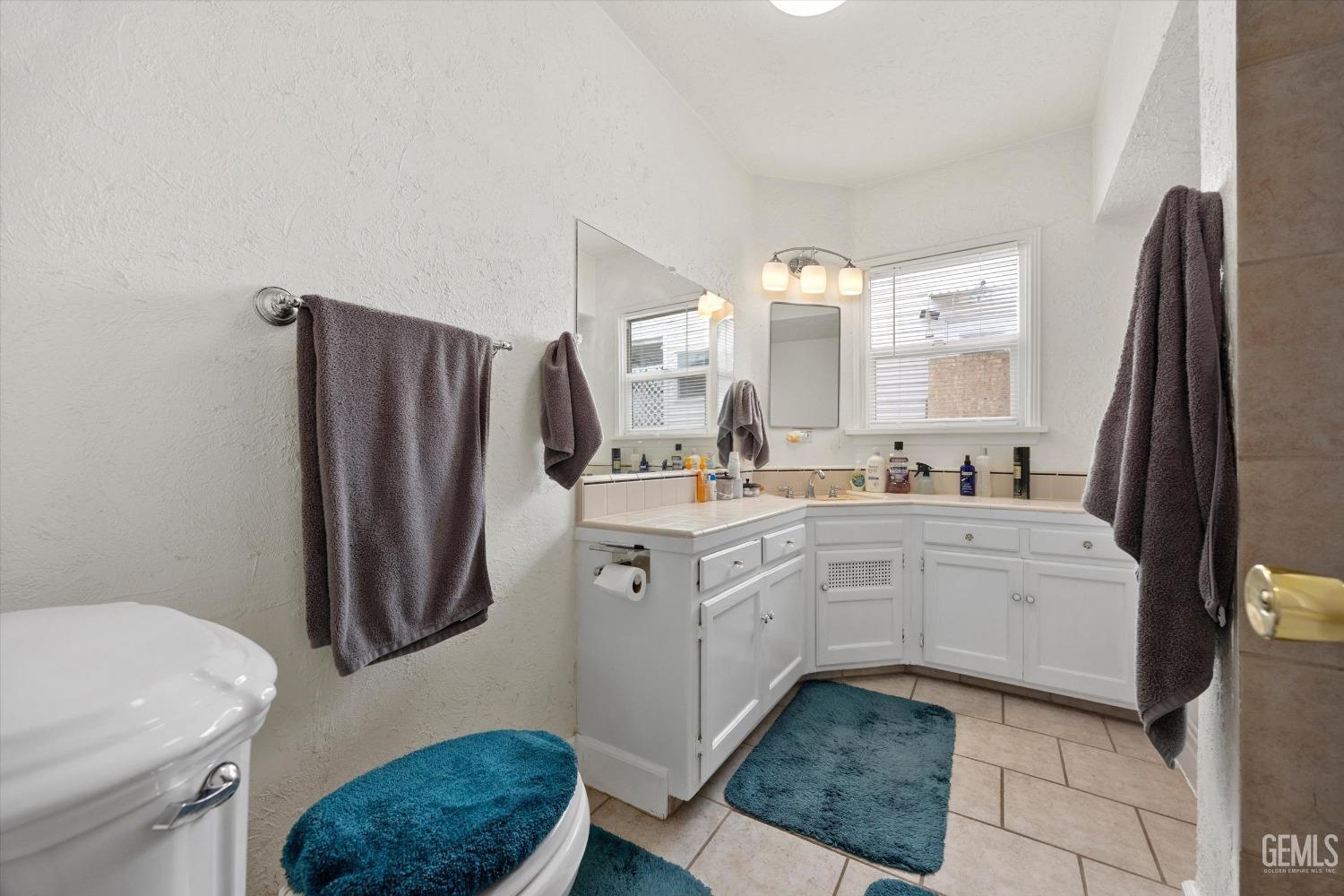 Undisclosed Address Bakersfield, CA 93305 - Photo 29 of 46 a kitchen with white cabinets and white appliances