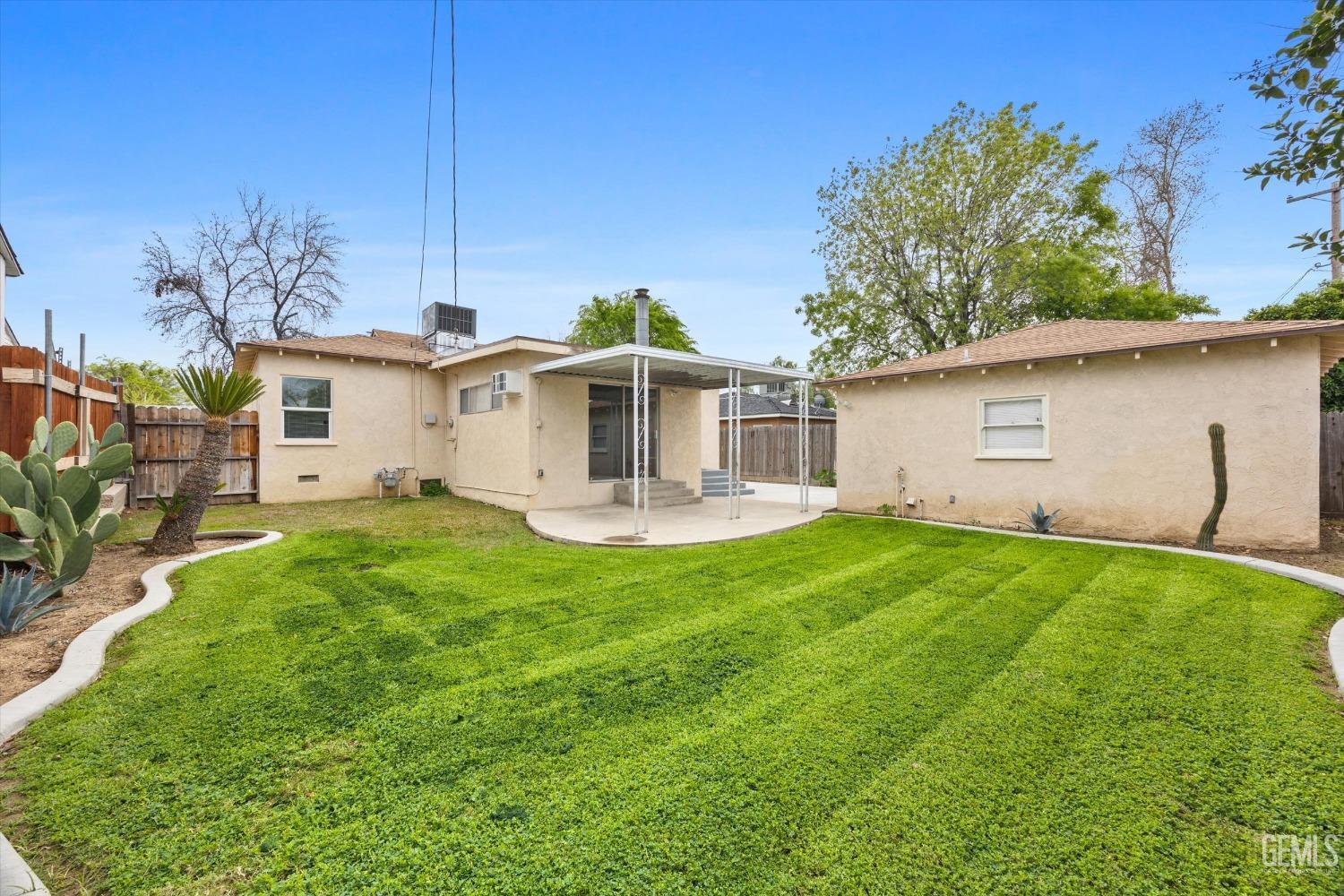 Undisclosed Address Bakersfield, CA 93305 - Photo 37 of 46 a front view of a house with a garden