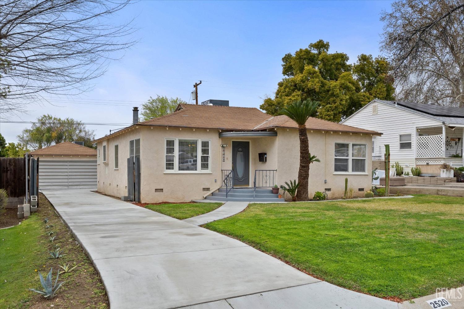 Undisclosed Address Bakersfield, CA 93305 - Photo 10 of 46 a front view of a house with a garden and yard