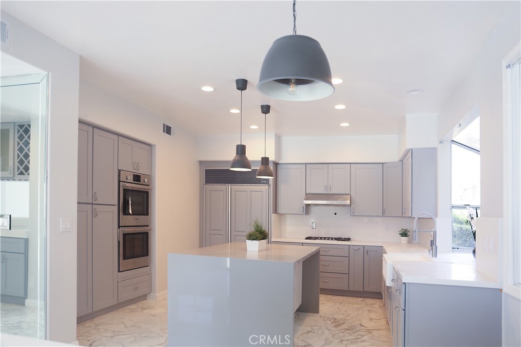 24825 Alexandra Court Calabasas, CA 91302 - Photo 3 of 13 a large kitchen with cabinets
