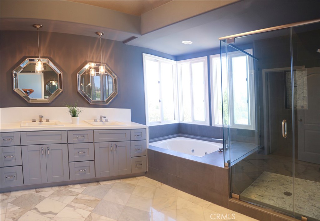 24825 Alexandra Court Calabasas, CA 91302 - Photo 7 of 13 a bathroom with a double vanity sink mirror and bathtub