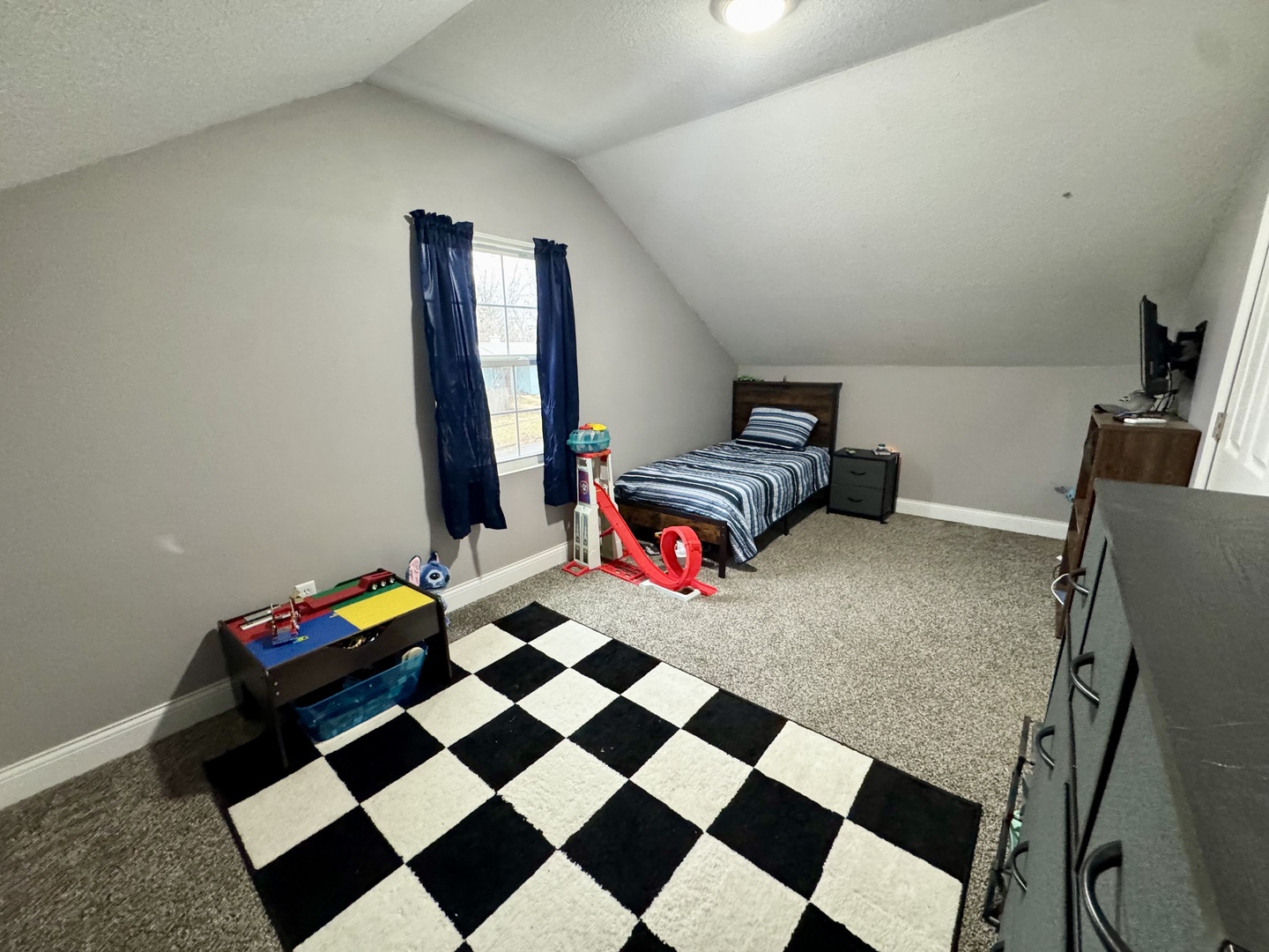 402 North Center Street Colfax, IL 61728 - Photo 20 of 25 a living room with a black white checkered floor with a gaming machine and appliances