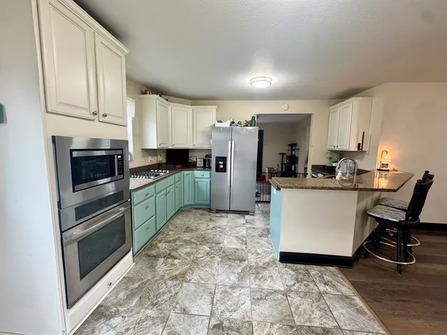 a kitchen with refrigerator cabinets and furniture