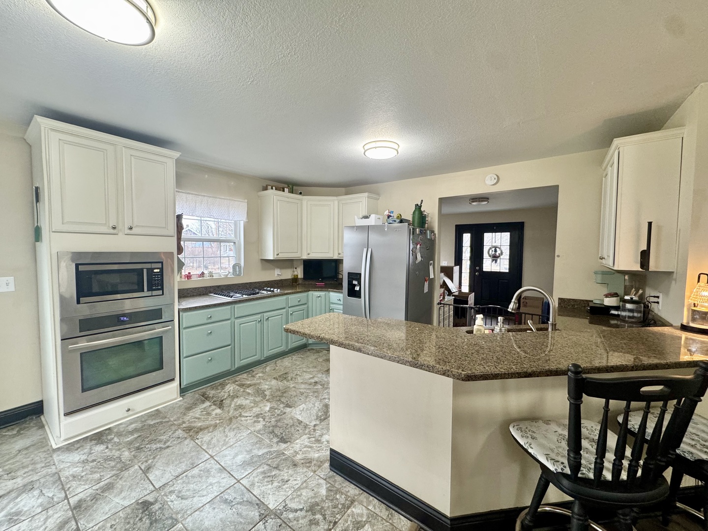 402 North Center Street Colfax, IL 61728 - Photo 6 of 25 a kitchen with kitchen island granite countertop a stove and a sink