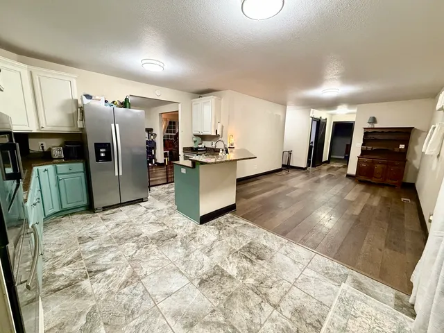 a kitchen with stainless steel appliances granite countertop a sink stove and cabinets