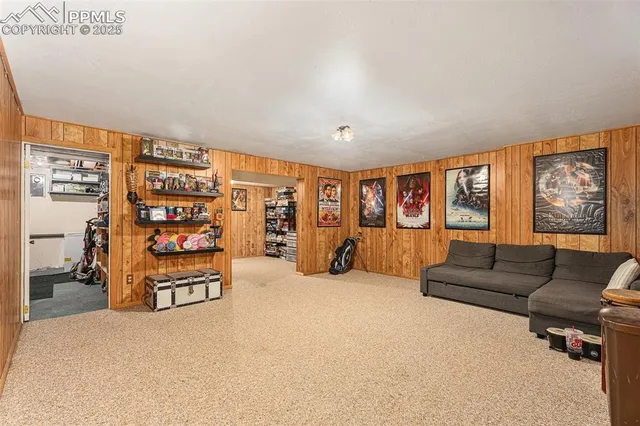 a living room with furniture a ceiling fan and a window