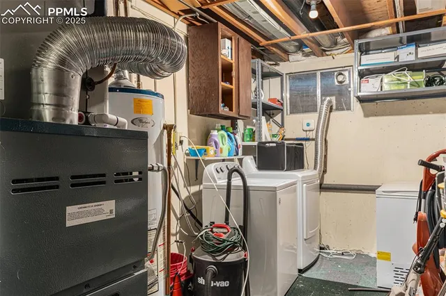 a view of storage and utility room with washer and dryer
