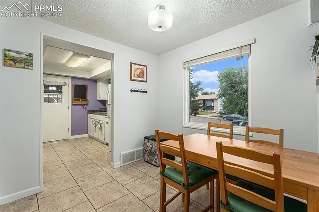 a dining room with furniture and window