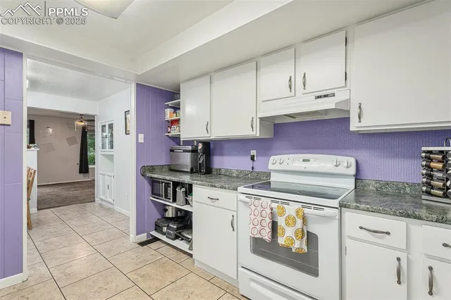 a kitchen with a stove and cabinets