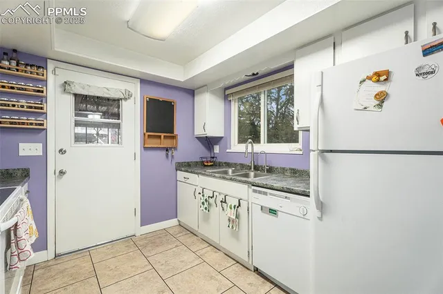a kitchen with stainless steel appliances granite countertop a refrigerator and a stove