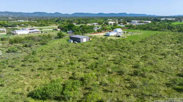 a view of a lush green outdoor space with a mountain view