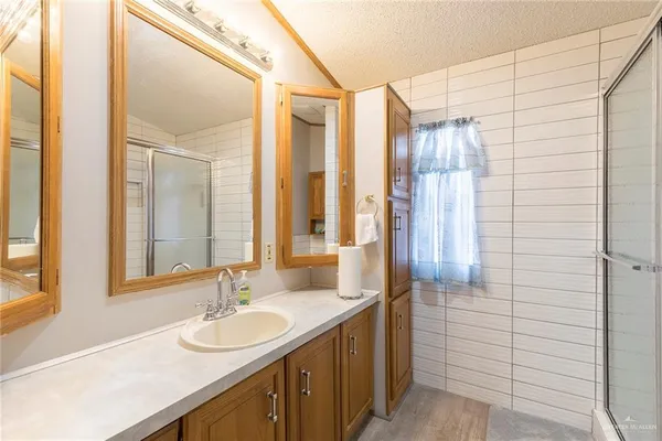 a bathroom with a double vanity sink and a mirror