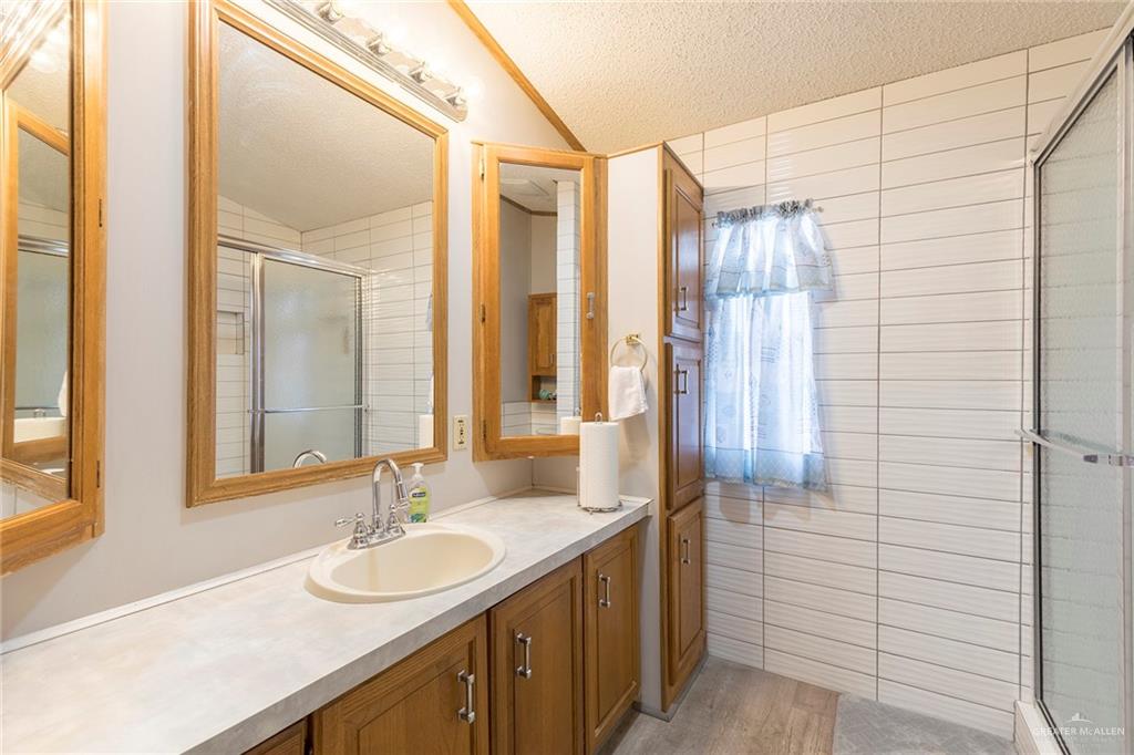 405 Cory Drive Mission, TX 78572 - Photo 12 of 13 a bathroom with a double vanity sink and a mirror