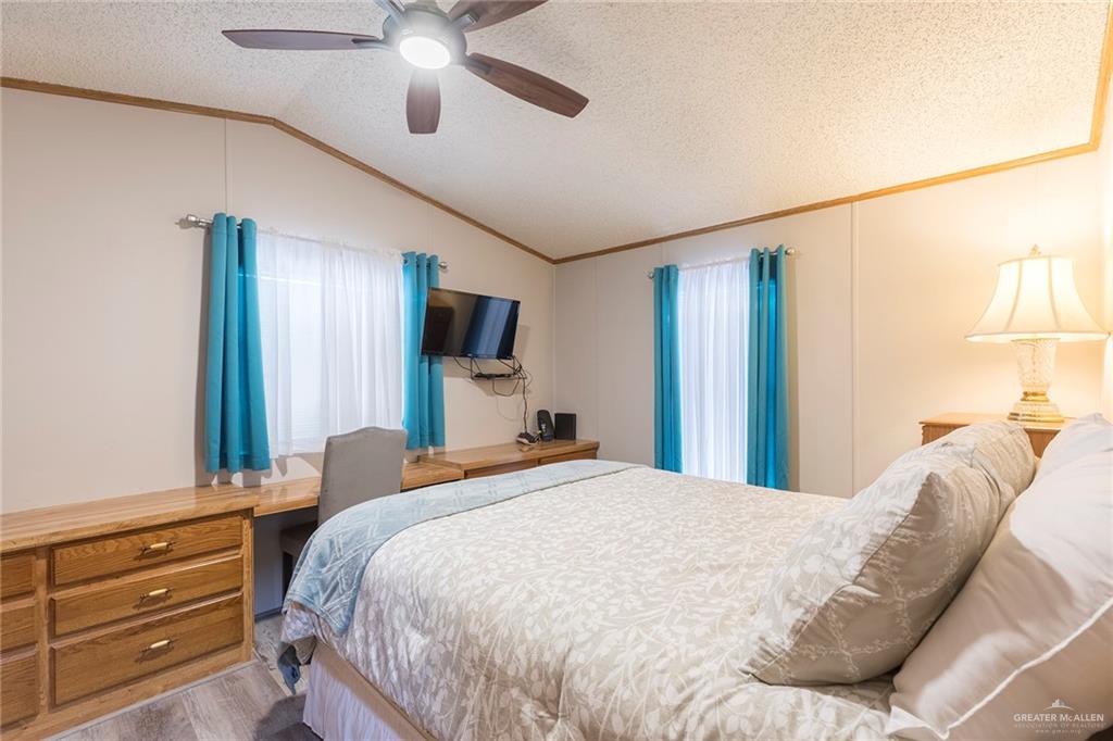 405 Cory Drive Mission, TX 78572 - Photo 8 of 13 a bedroom with a bed a window and a chandelier