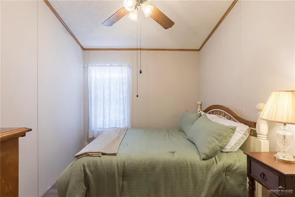 a bedroom with a bed and a lamp