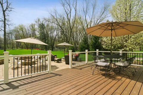 a view of a deck with furniture and umbrella