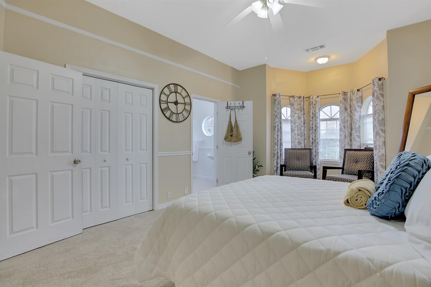 1408 Hazel Street Gridley, CA 95948 - Photo 21 of 60 a large bedroom with a bed and a chandelier