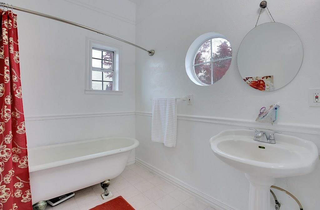 1408 Hazel Street Gridley, CA 95948 - Photo 30 of 60 a bathroom with a sink a mirror and a bathtub