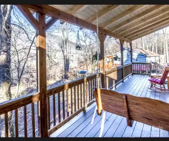 a view of a wooden deck with furniture