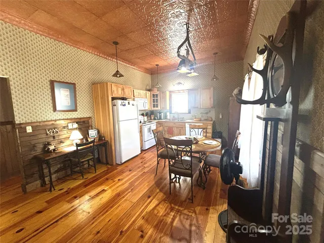 a dining room with furniture and a large window