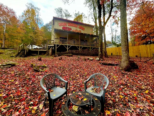 a view of a chairs and table in backyard