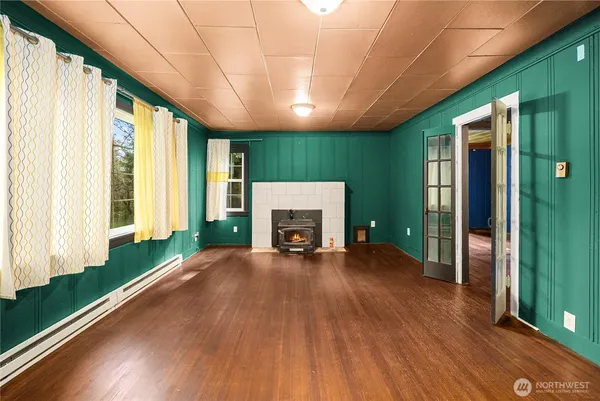 a view of a livingroom with a fireplace and window