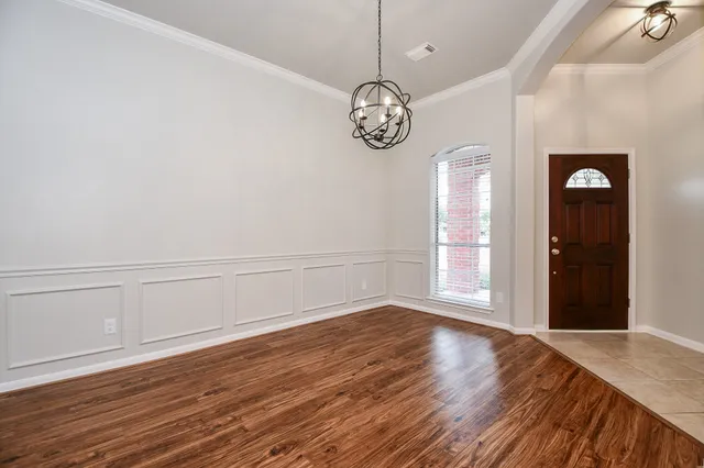 a view of a room with wooden floor