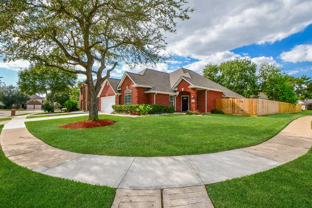 a front view of house with yard and green space