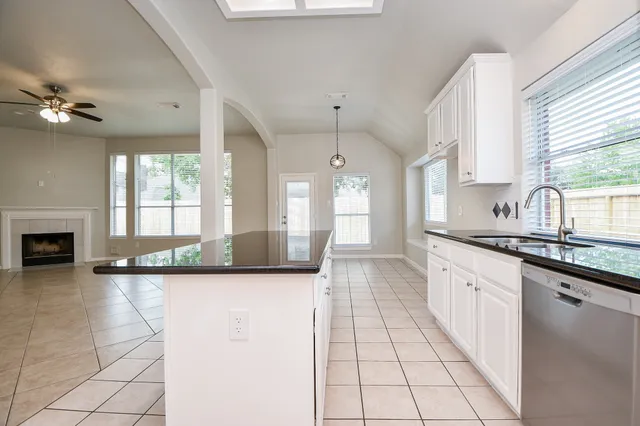 a large white kitchen with a large window