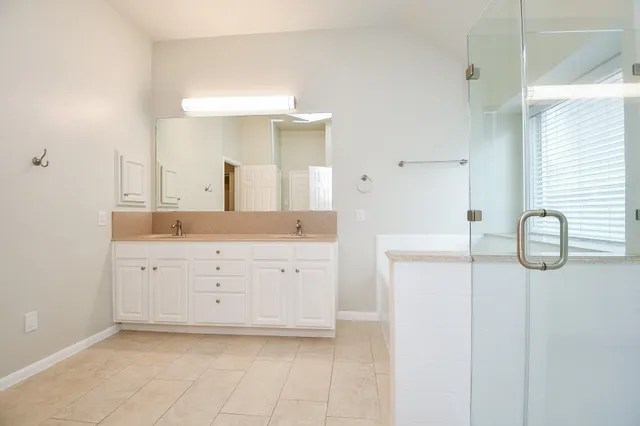 a spacious bathroom with a sink and a mirror