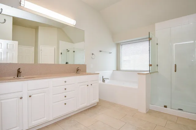 a bathroom with a granite countertop sink a toilet and bathtub