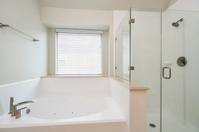a white bath tub sitting next to a window