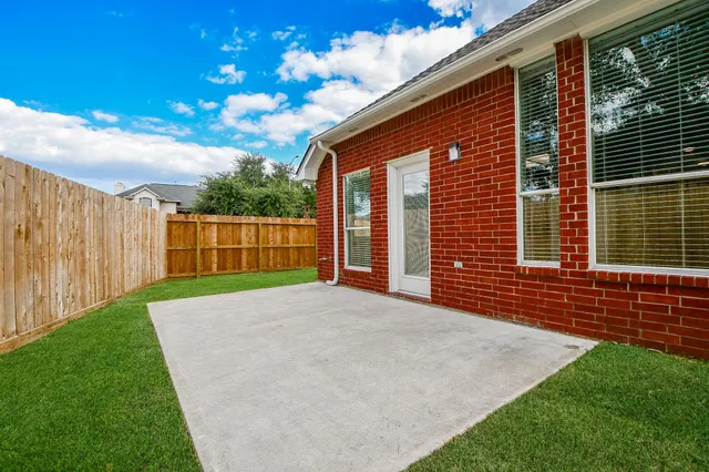 a front view of a house with a garden and yard