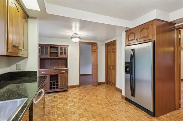 a kitchen with stainless steel appliances granite countertop a refrigerator and a stove top oven