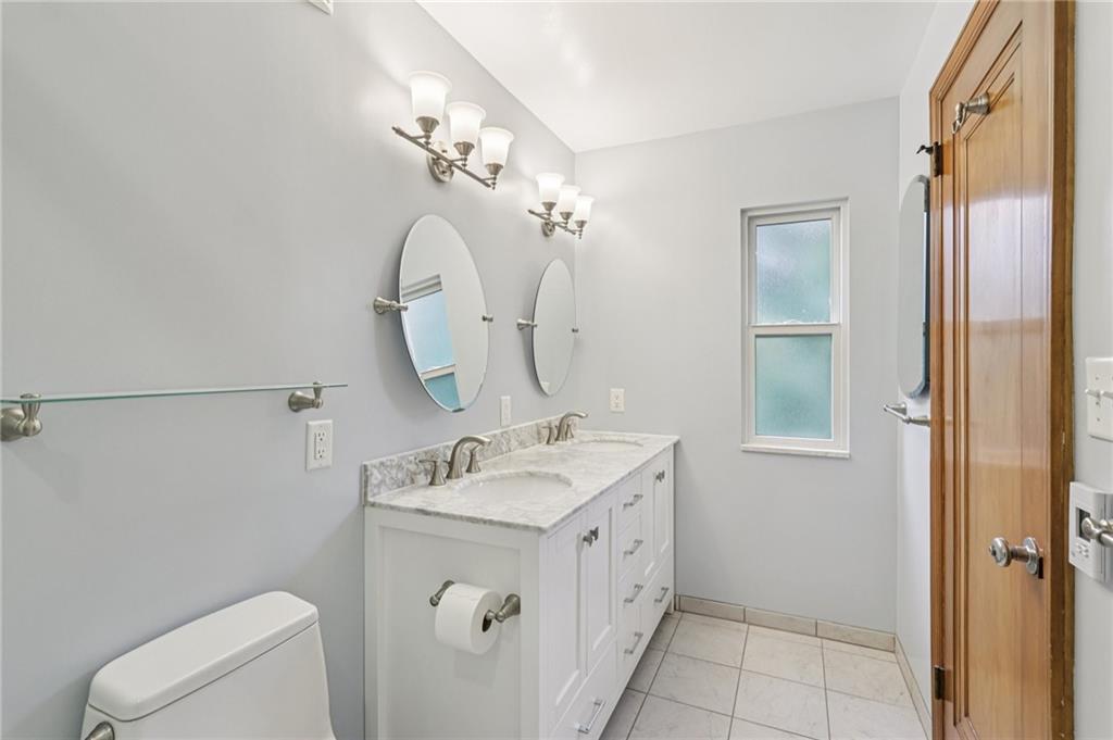 12 Holland Road Pittsburgh, PA 15235 - Photo 23 of 49 a bathroom with a sink mirror and toilet