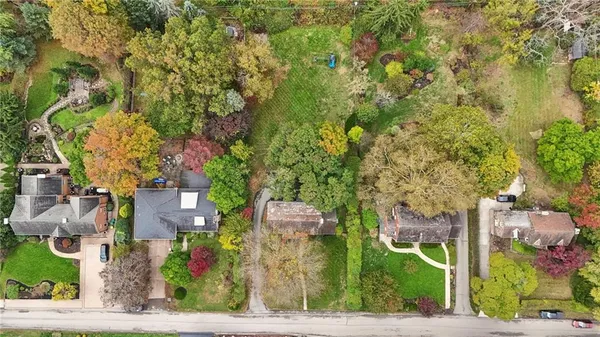 an aerial view of residential houses with outdoor space and street view