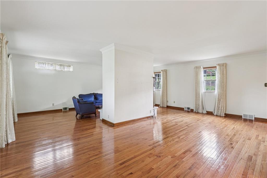 12 Holland Road Pittsburgh, PA 15235 - Photo 6 of 49 a view of an empty room with wooden floor and a window