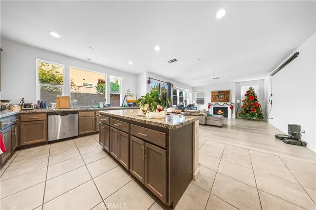 a kitchen with a refrigerator and a stove top oven