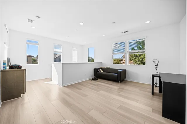 a living room with furniture and kitchen view