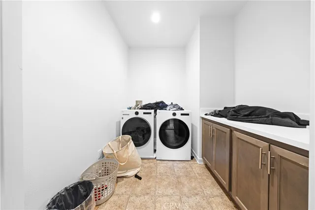 a utility room with sink dryer and washer