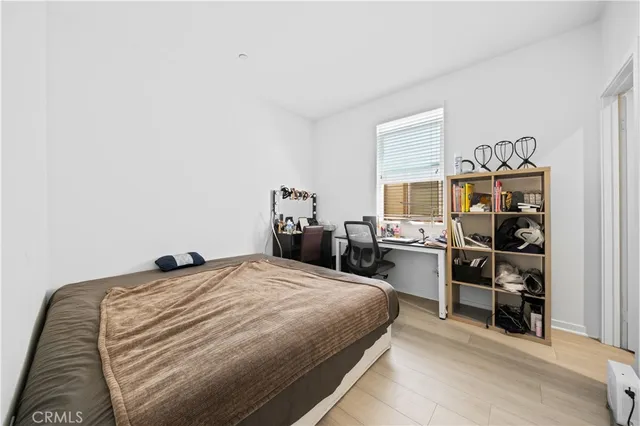 a bed room with a bed and a chair