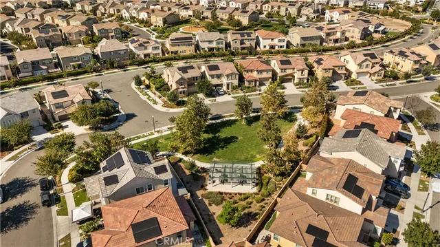 an aerial view of residential houses with yard