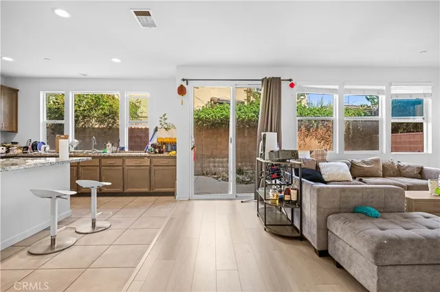 a kitchen with stainless steel appliances granite countertop a sink counter space cabinets and a large window