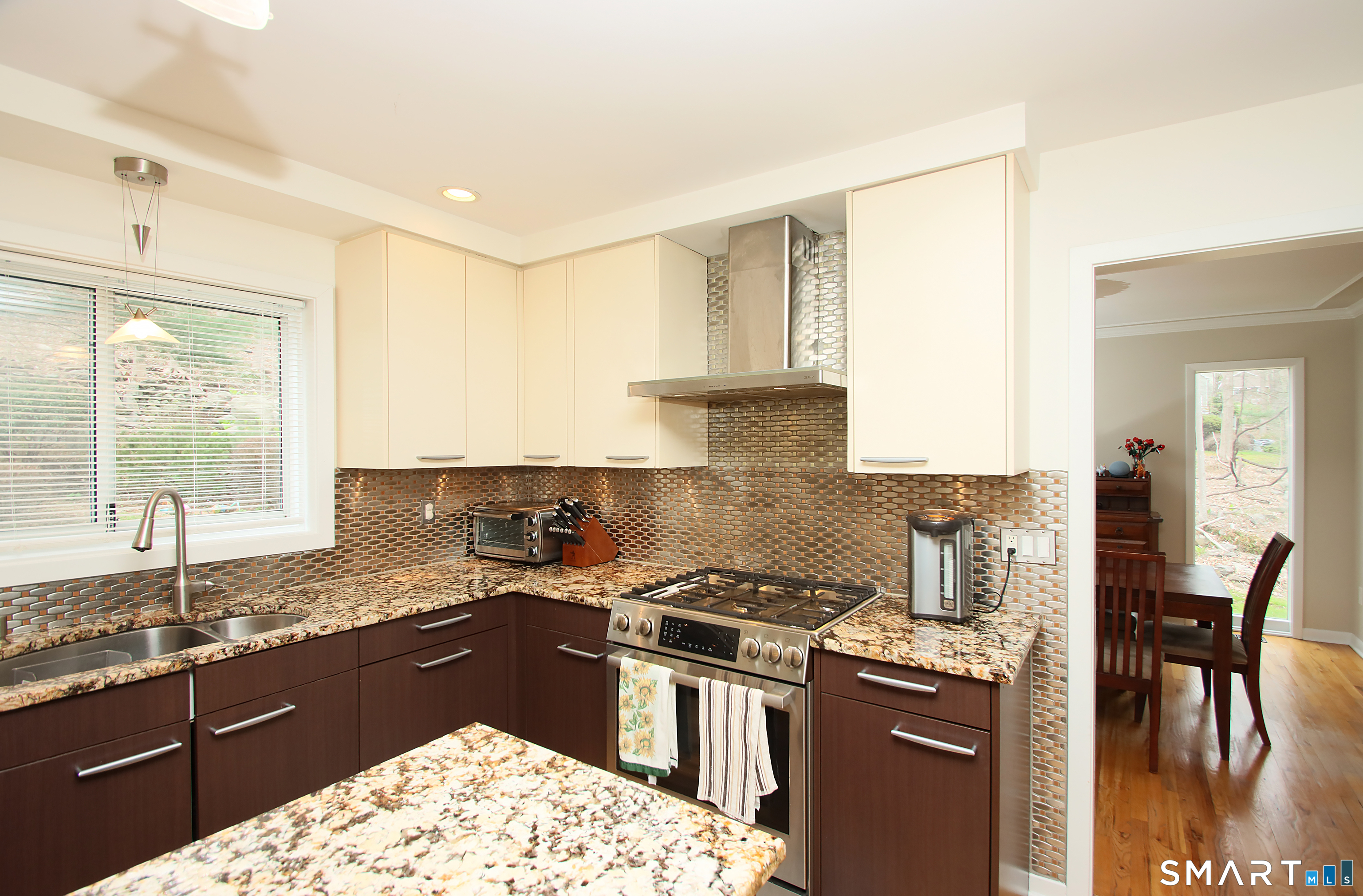 78 Sturbridge Road Easton, CT 06612 - Photo 12 of 35 a kitchen with granite countertop a stove a sink and a wooden cabinets
