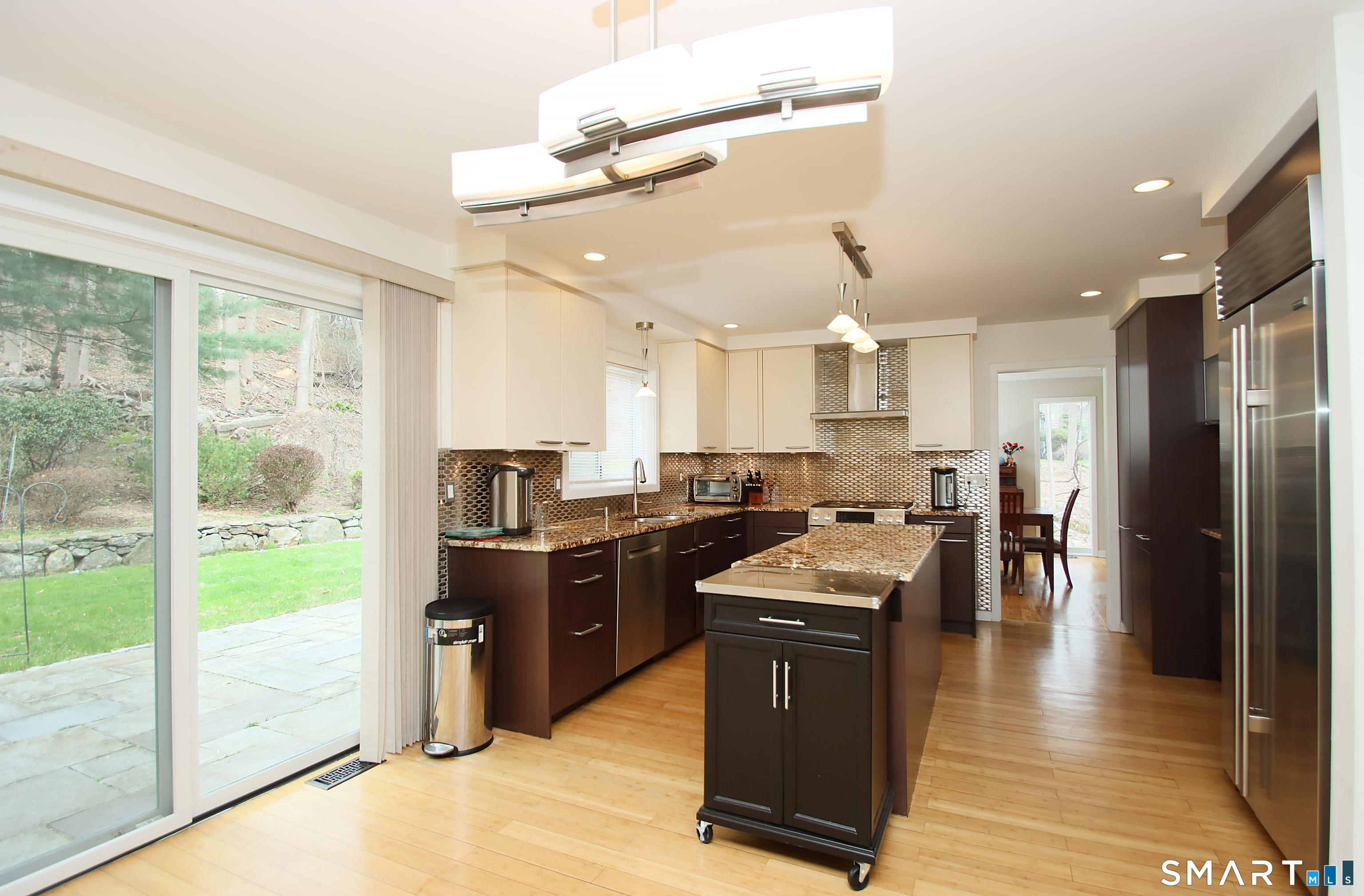 78 Sturbridge Road Easton, CT 06612 - Photo 10 of 35 a kitchen with stainless steel appliances granite countertop a refrigerator a sink dishwasher a stove and a dining table with wooden floor
